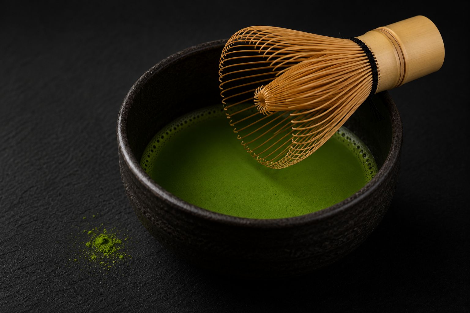 Matcha whisked in a black chawan bowl